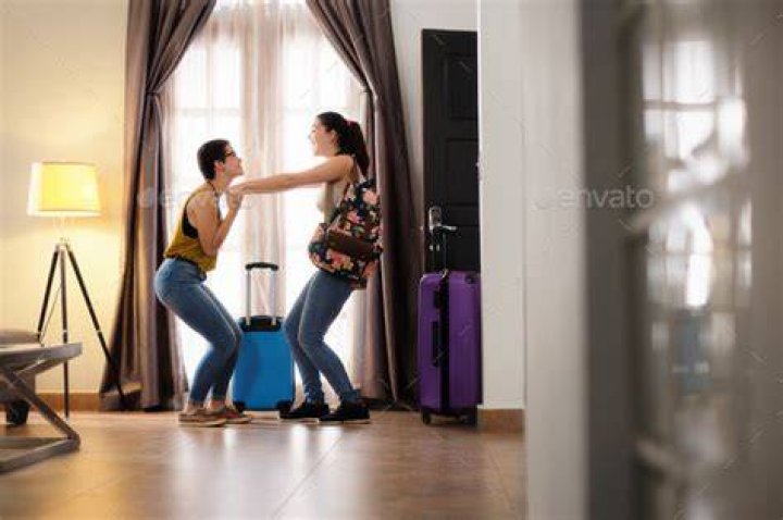 Happy Lesbian Women In Hotel Room On Holidays Couple Travel Stock Photo